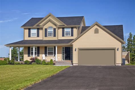 tan house with black metal roof|tan houses with black trim.